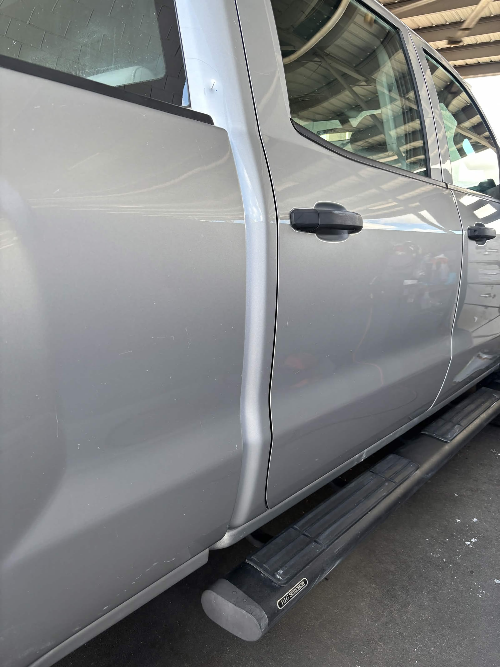 Silver pickup truck doors and running board after exterior detailing