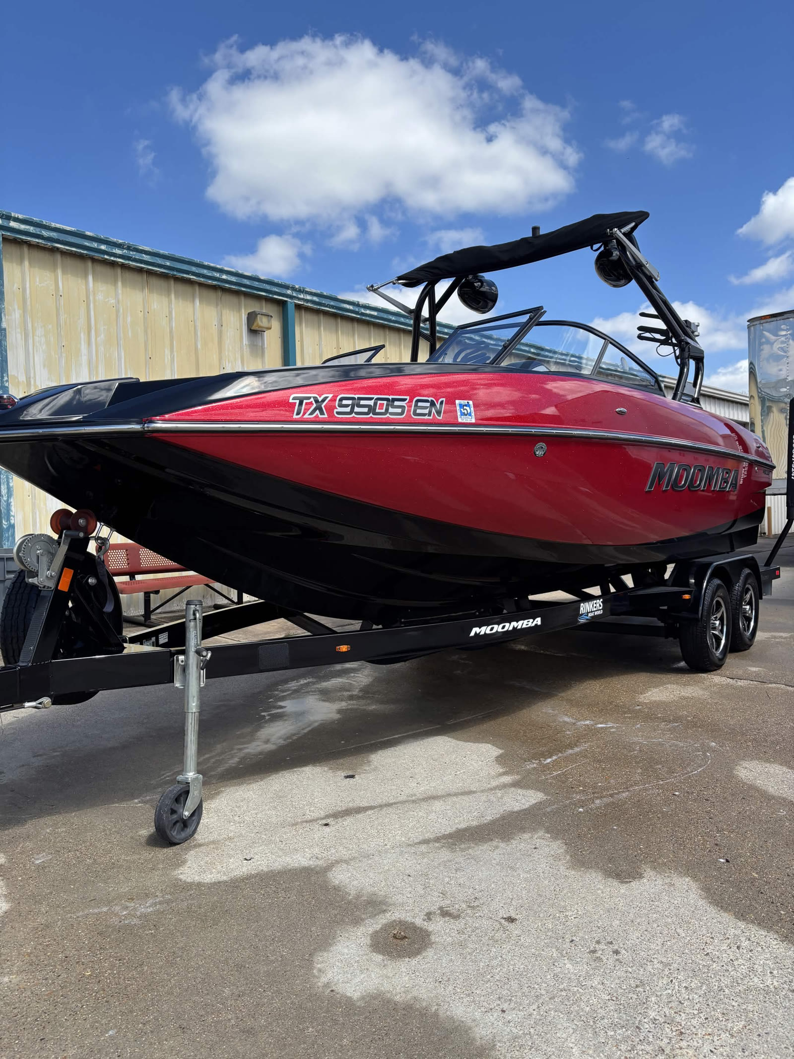 Red and black Moomba boat on trailer after detailing