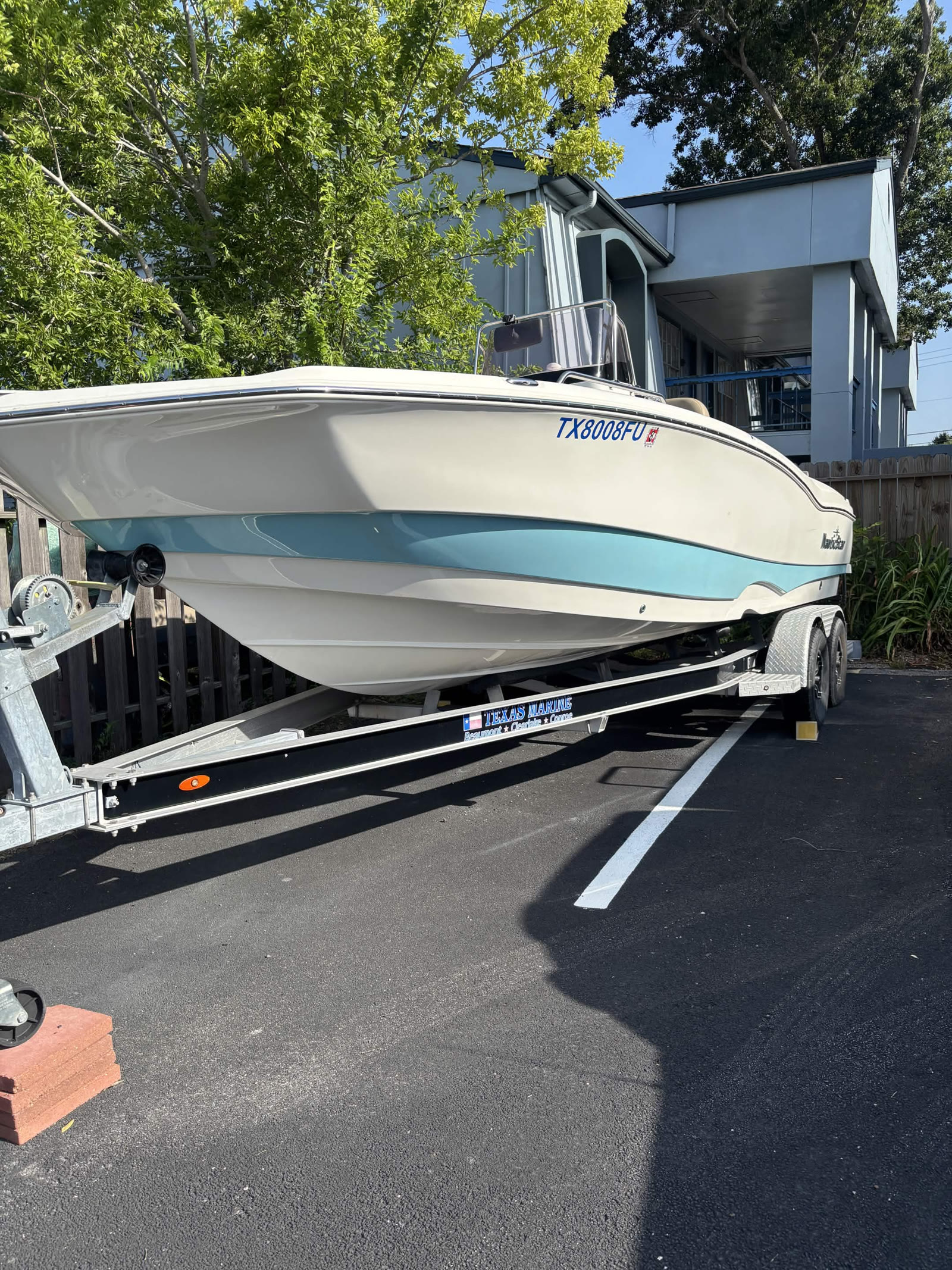 White and blue NauticStar boat on trailer after detailing