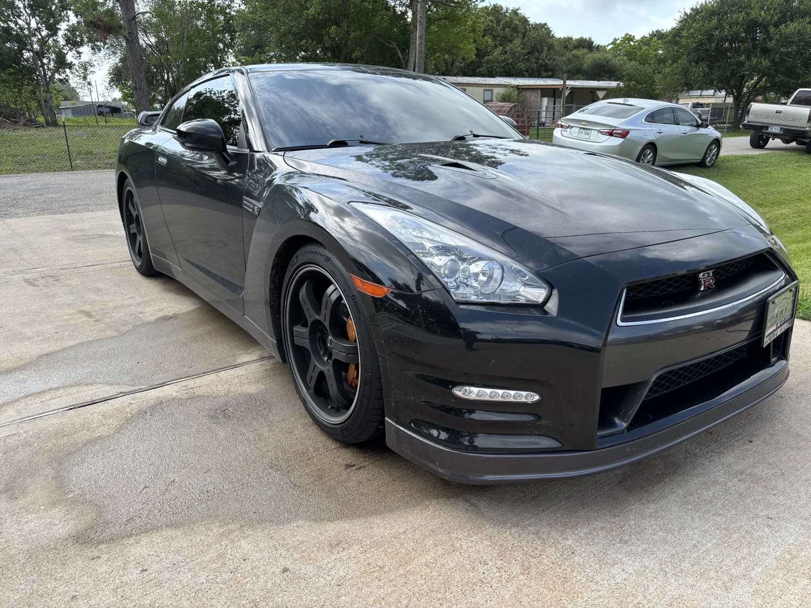 Black Nissan GT-R front detail with orange calipers after detailing