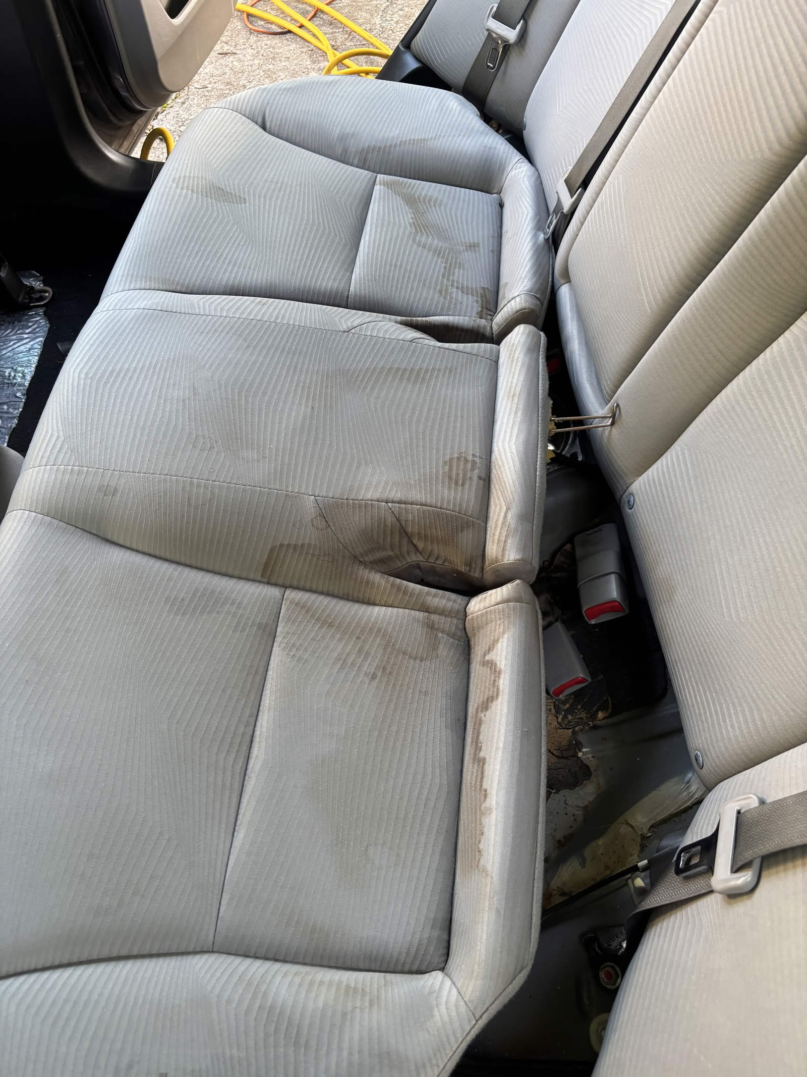 Stained fabric rear bench seat before shampoo